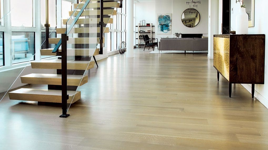 a beautiful polished hardwood floor and staircase in picture.