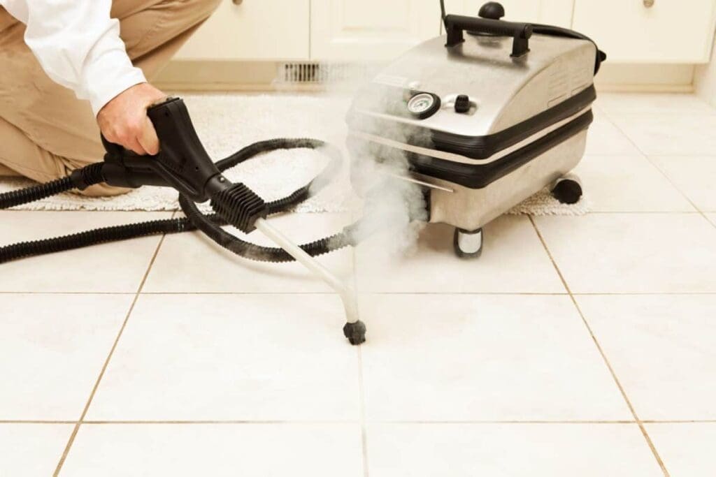 a person steam cleaning grout with steamer