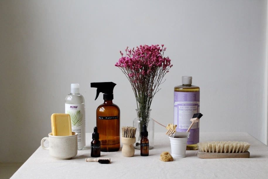 empty bottles and sprays on table without label in picture.